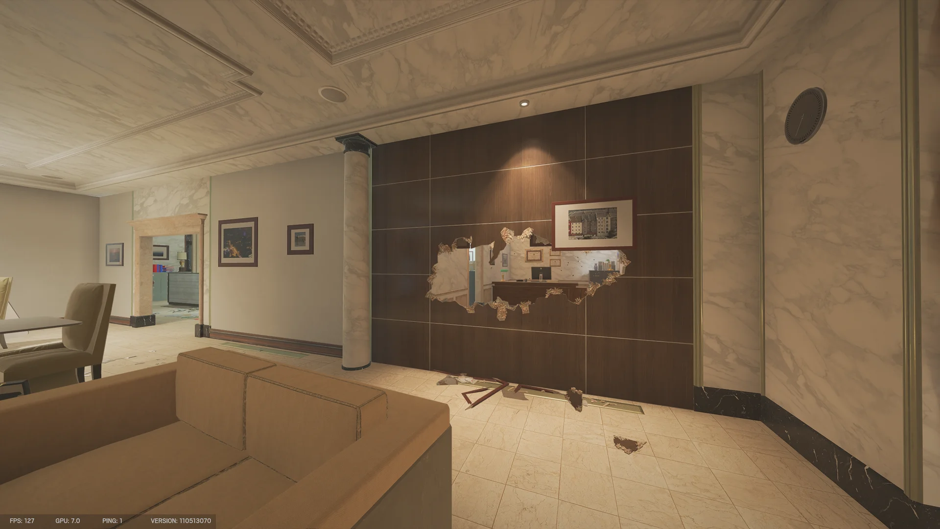 Lounge on Bank 1F with a tan sofa facing a dark wood wall, a hole in the paneling revealing an office desk and monitor