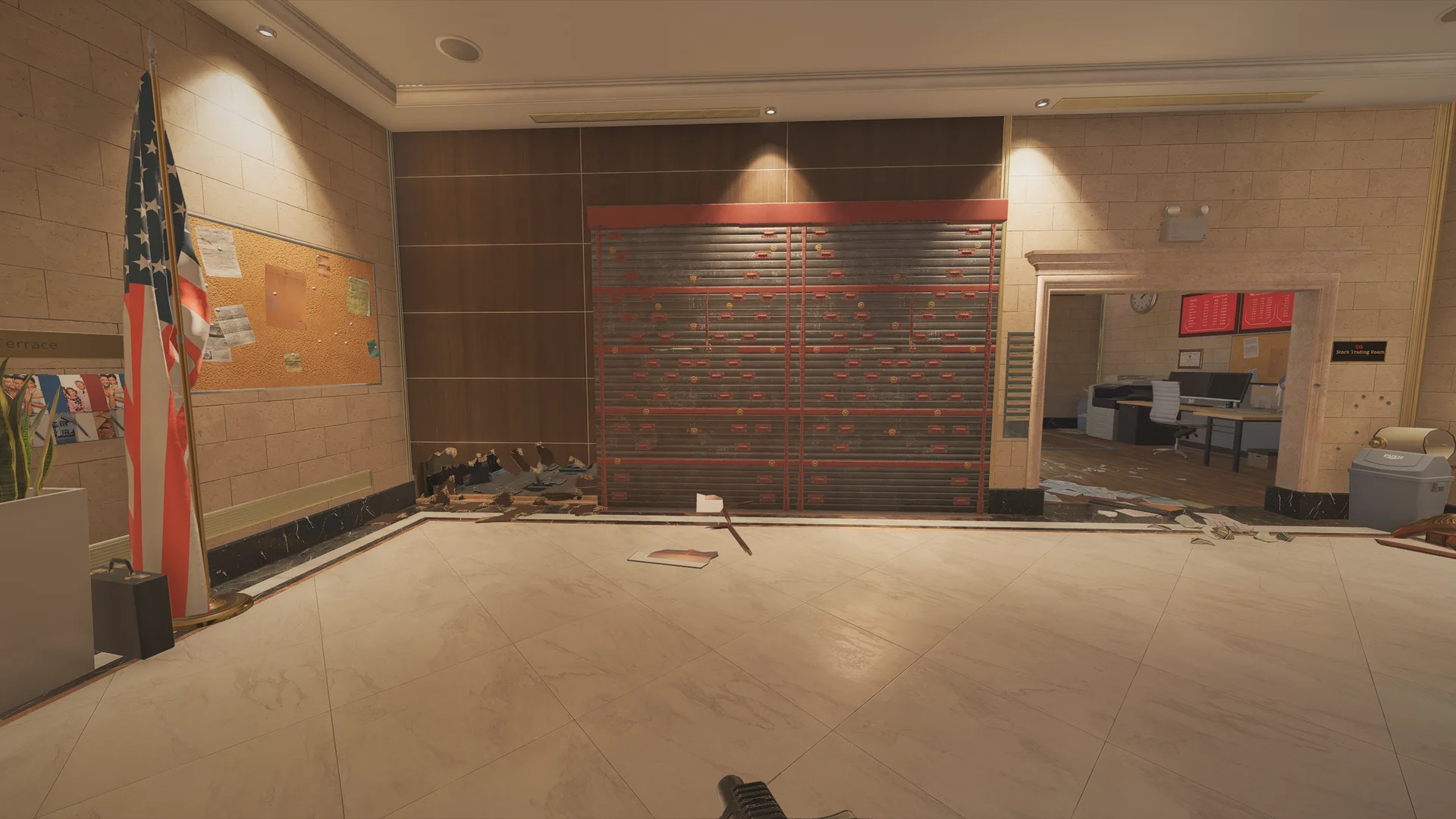 Room on Bank 2F with an American flag and corkboard at left, a wide reinforced wall, and an office with red screens beyond
