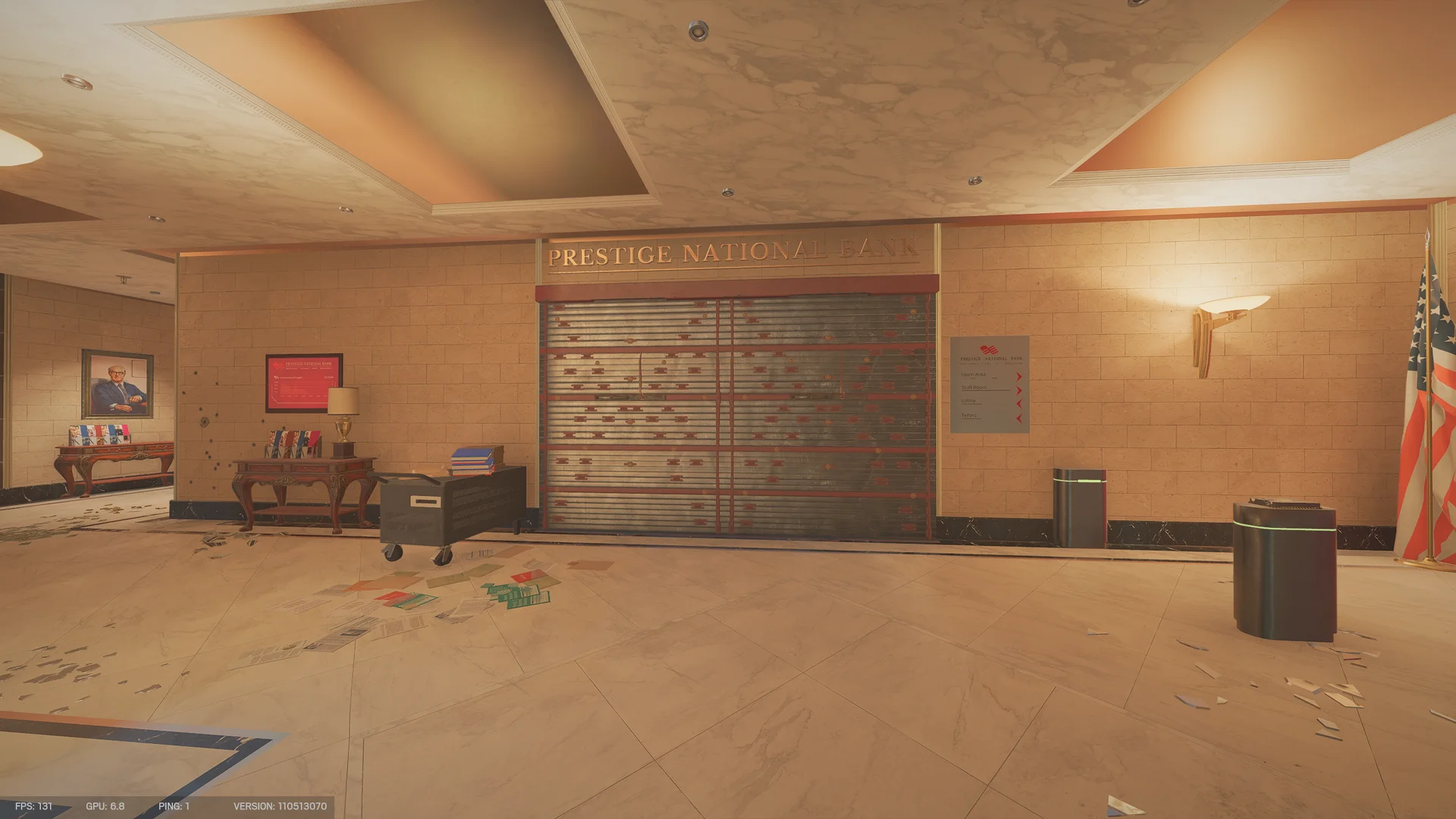 Bank hall with gold lettering above a red-and-grey metal shutter wall, side tables, an American flag and papers on the floor