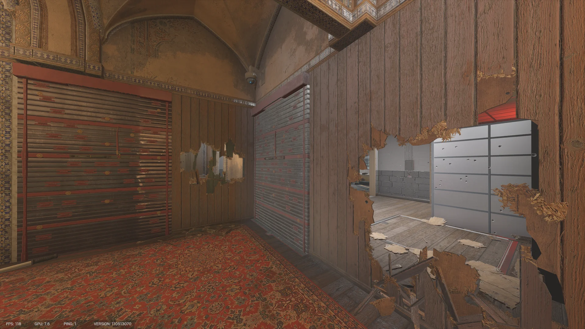 Vaulted room on Border with a red rug, two closed metal shutters, and a large ragged hole in a wooden wall opening to a grey room with metal cabinets