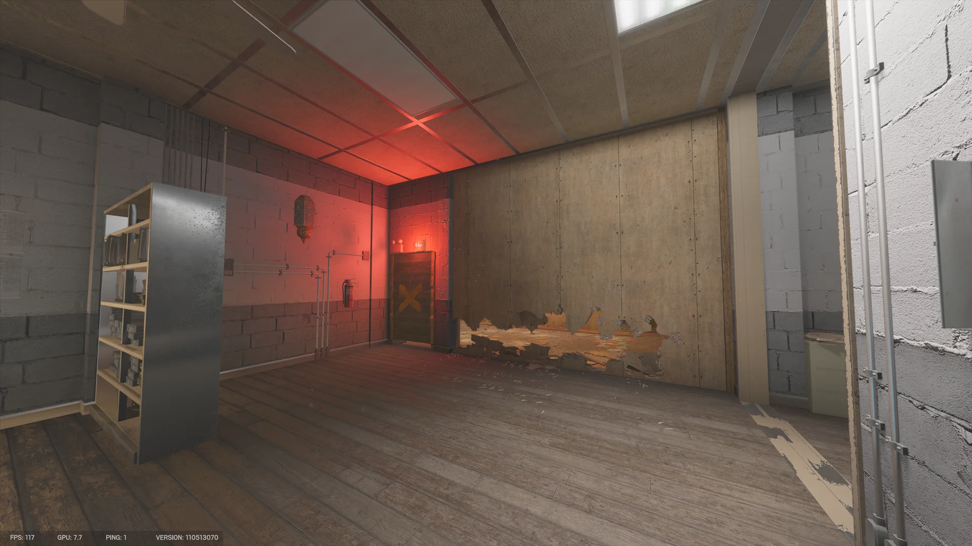 Blockwork room on Border lit by a red light, with a yellow-X-marked wooden door, a plywood wall stripped at its base, and a metal shelf of boxes at left