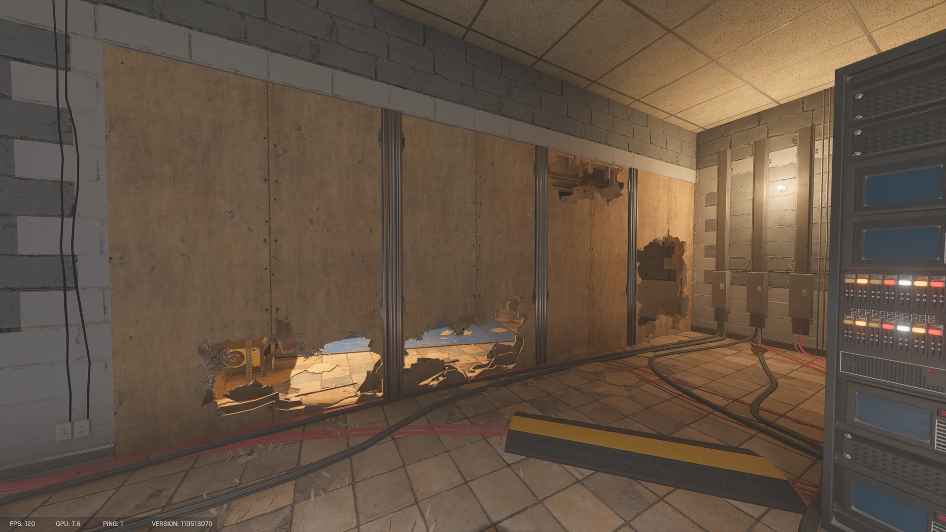 Tiled room on Border 1F with an electronics rack and a plywood wall broken open along the floor line, red cables and a yellow cable ramp crossing the tiles