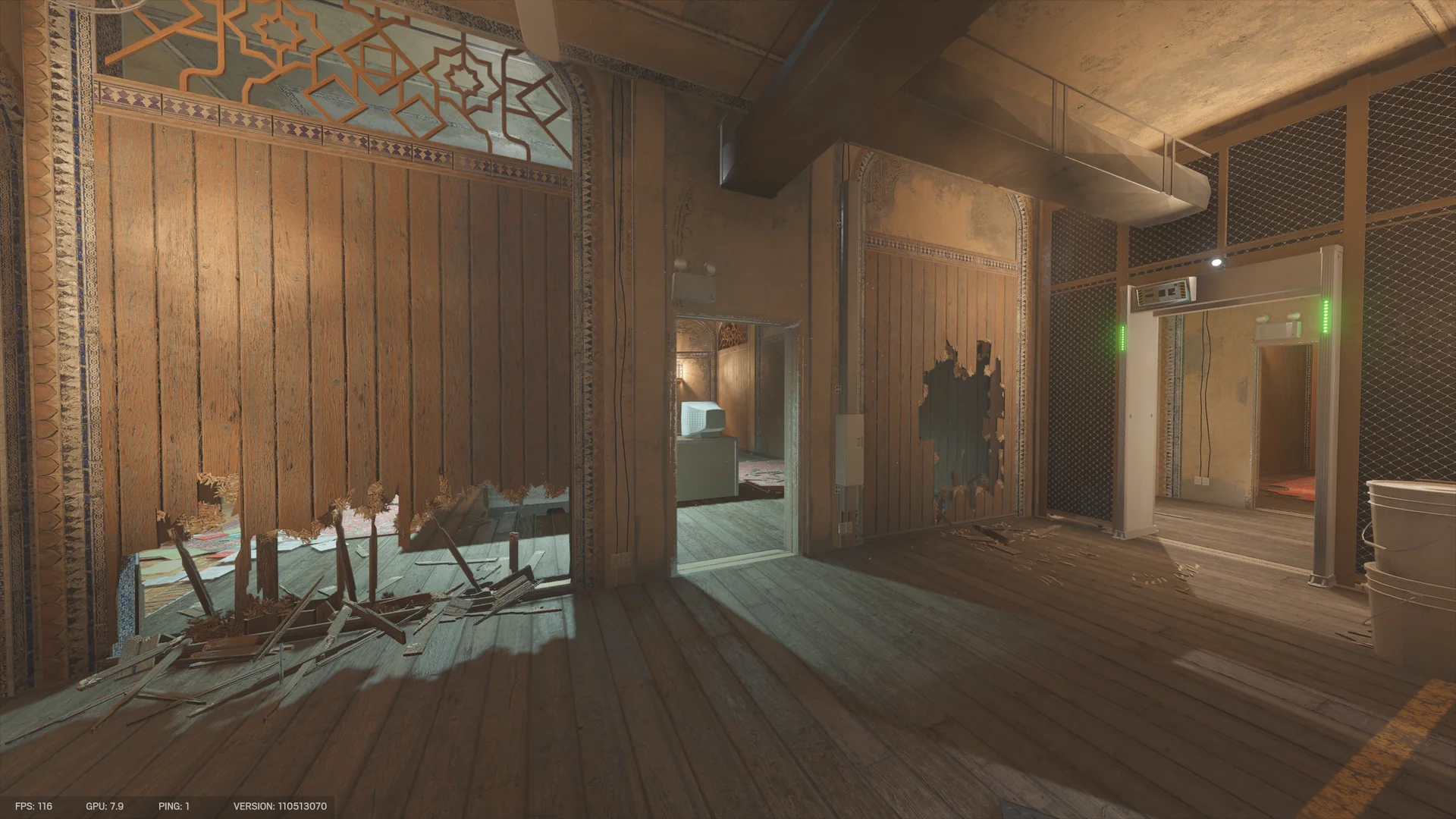 Wooden partitions on Border 2F with splintered holes, an open doorway to a room with a CRT monitor, and a metal detector gate at right
