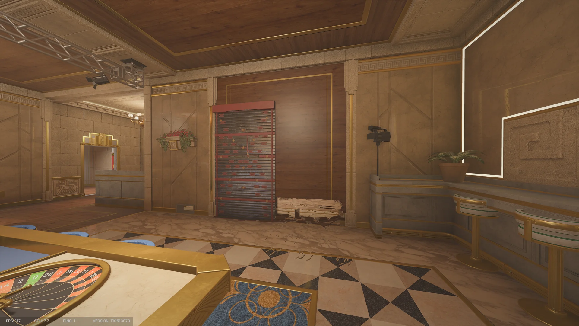 Casino room on Calypso Casino 1F with a roulette table and blue stools, a reinforced wall, and a camera on a tripod at right