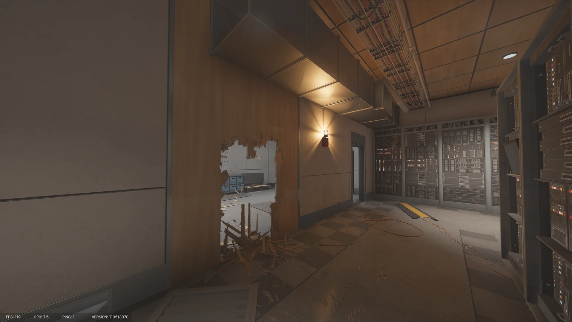 Corridor in the Calypso Casino basement with a breached wooden wall, panels of switchgear at right and cables on the floor