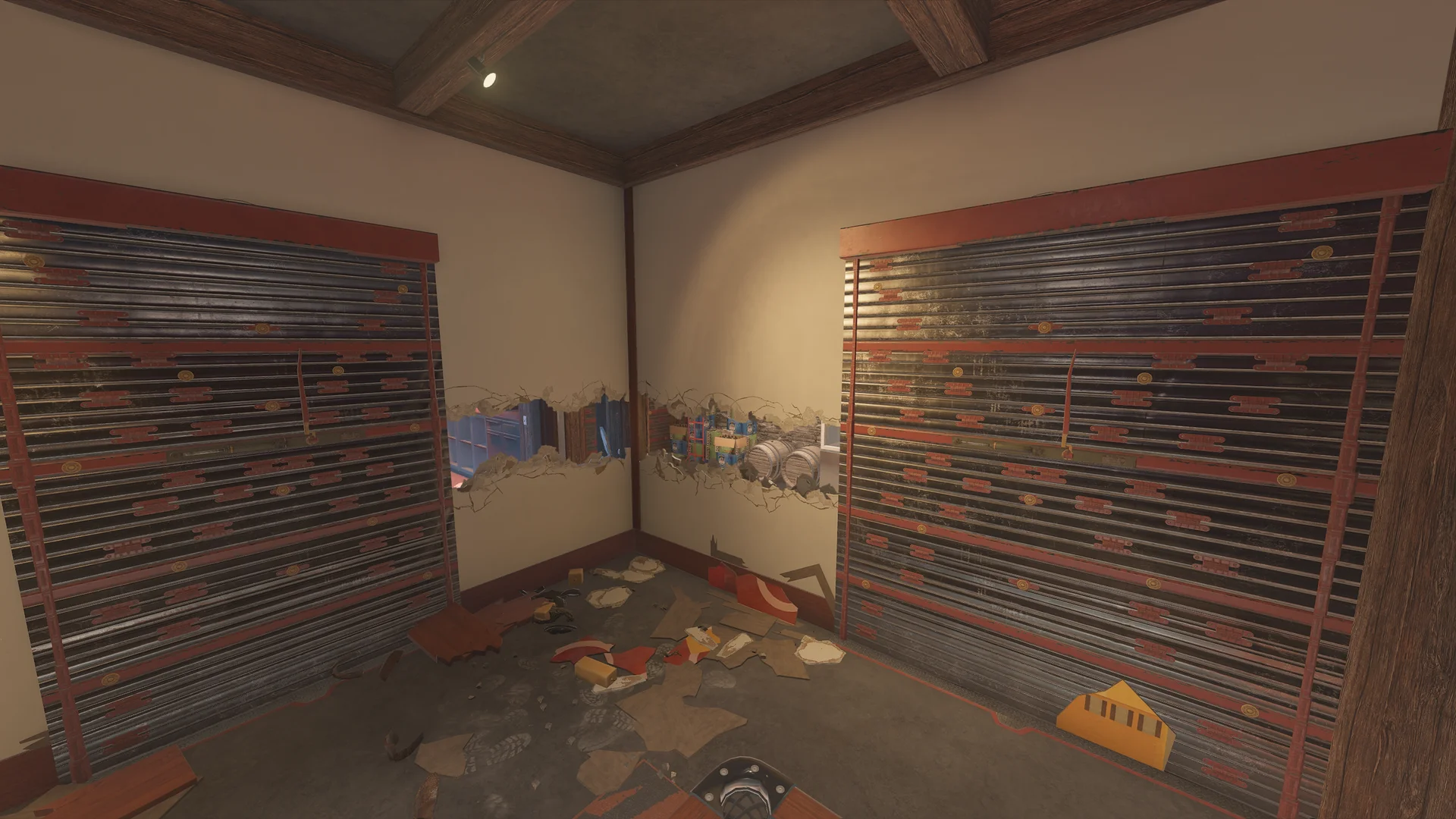 Corner room on Chalet 1F with two reinforced walls and breaches along both plaster walls revealing barrels and stacked boxes