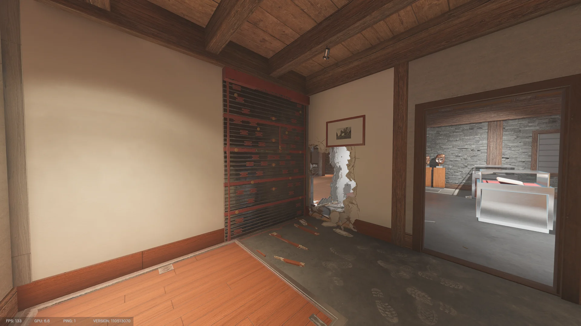 Room on Chalet 2F with a reinforced wall, a breach beside a framed picture, and a display-case room through the doorway