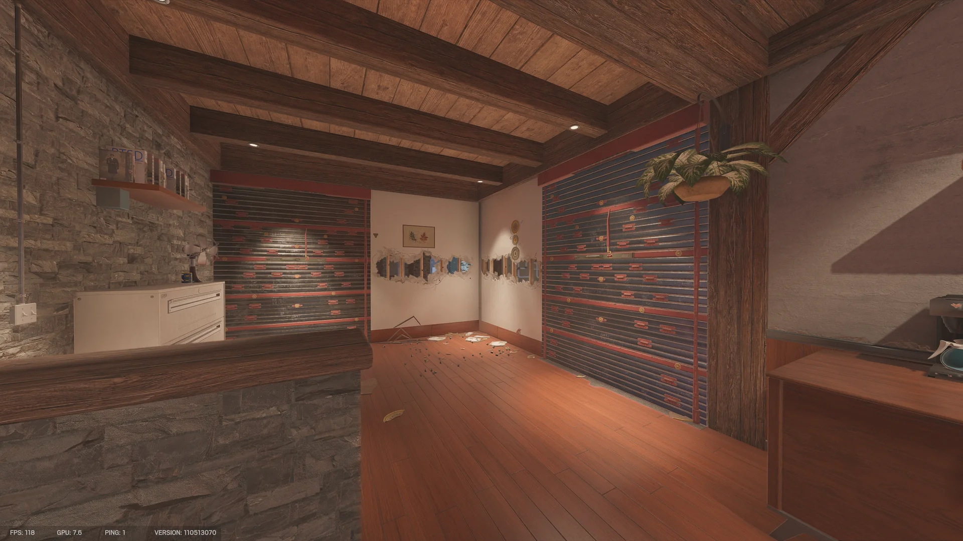 Room on Chalet 2F with two reinforced walls, a plaster wall broken by a row of holes, a hanging plant and a stone counter
