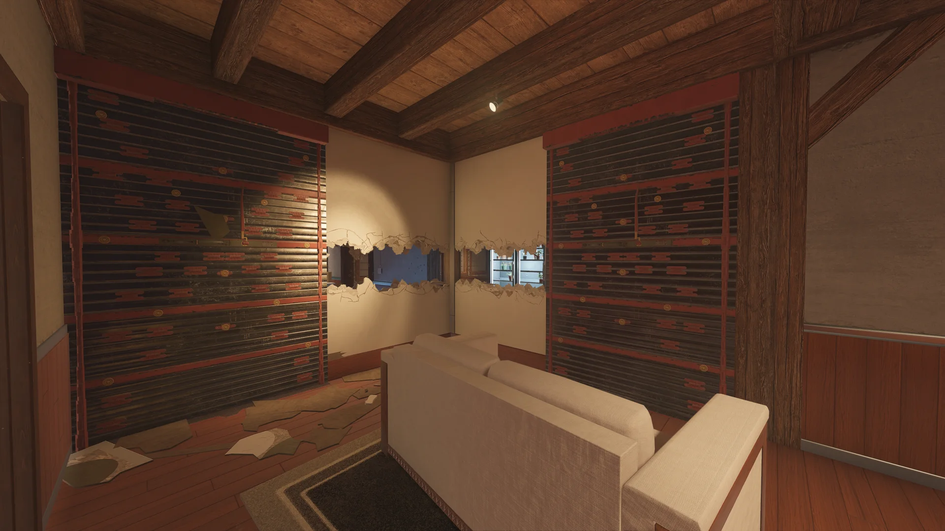 Room on Chalet 2F with two wide reinforced walls, a breached band of wall between them, and a pale sofa on a dark rug