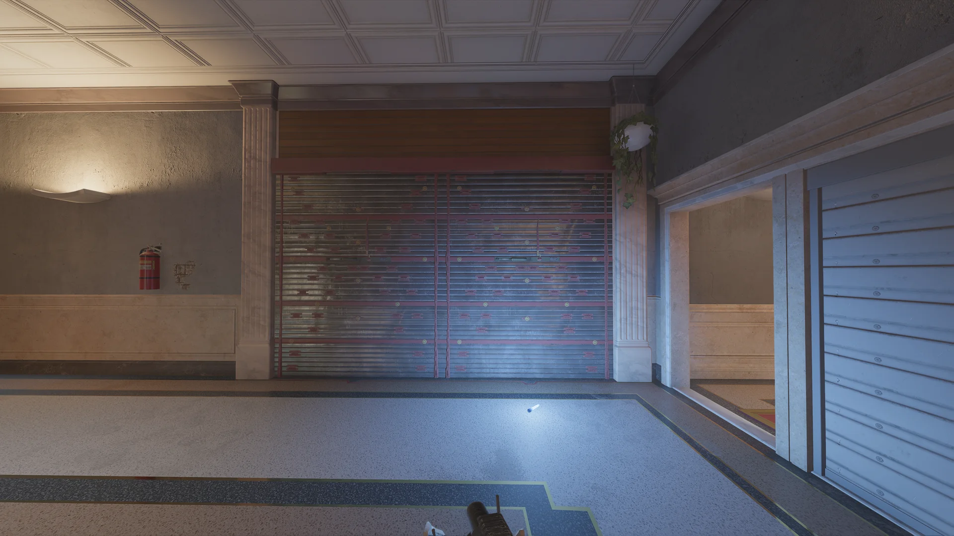 Lobby on Consulate 1F with a reinforced shutter wall, a fire extinguisher, a marble column, and a terrazzo floor