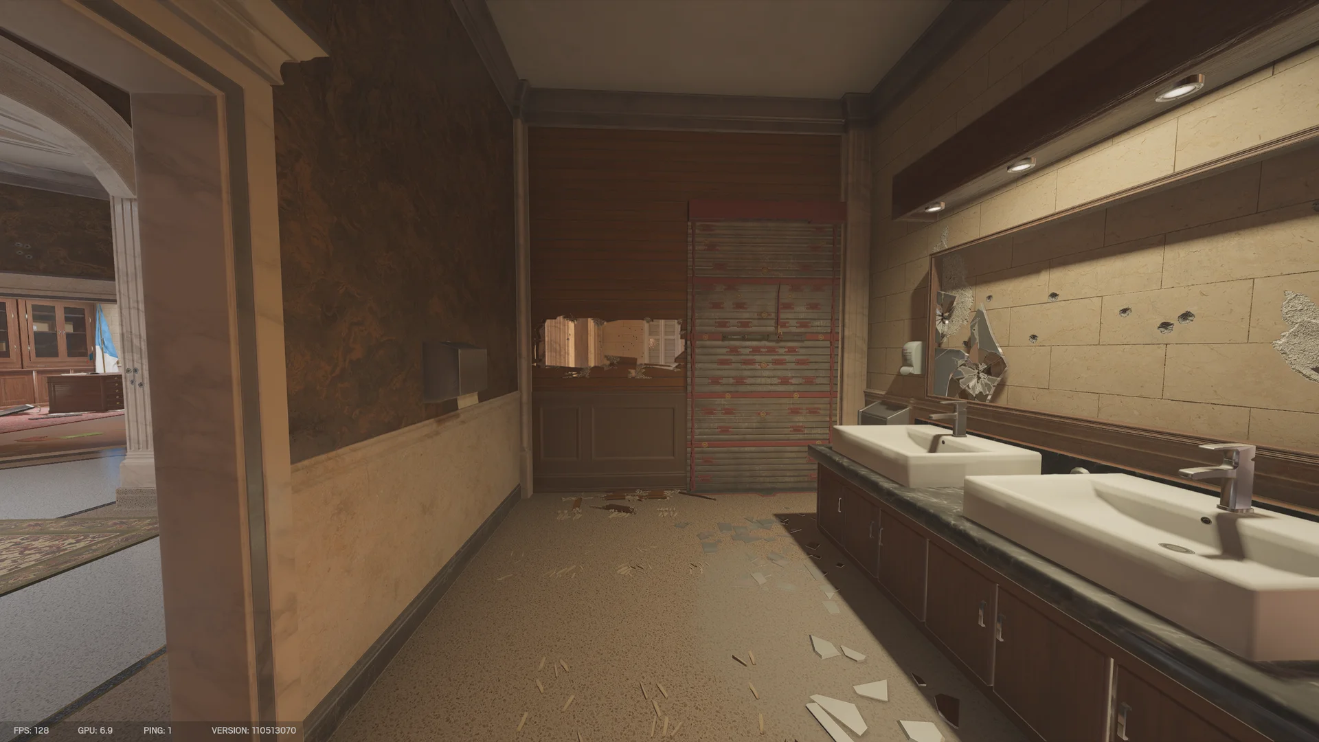 Restroom in the Consulate with a double sink vanity, a large mirror, a reinforced shutter, and a breach hole through a wood-panel wall