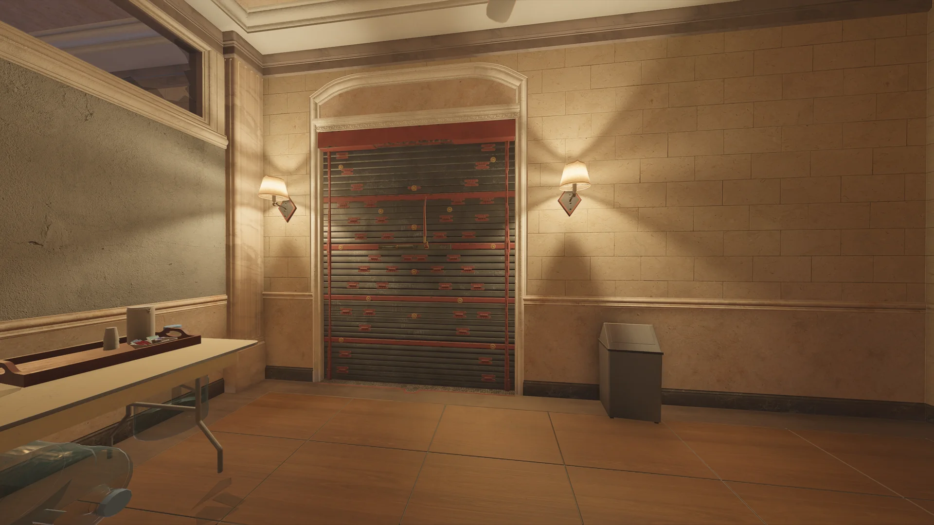 Stone-walled room in the Consulate with an arched reinforced shutter flanked by two wall lamps, a table with a tray, and a bin