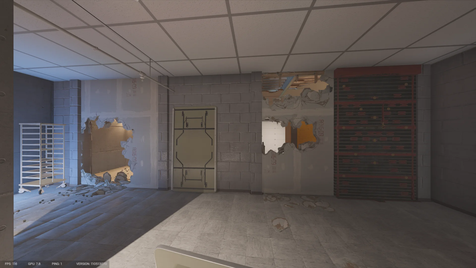 Basement room in the Consulate with a reinforced shutter, breach holes through the walls, a folded table, and a wheeled rack at left