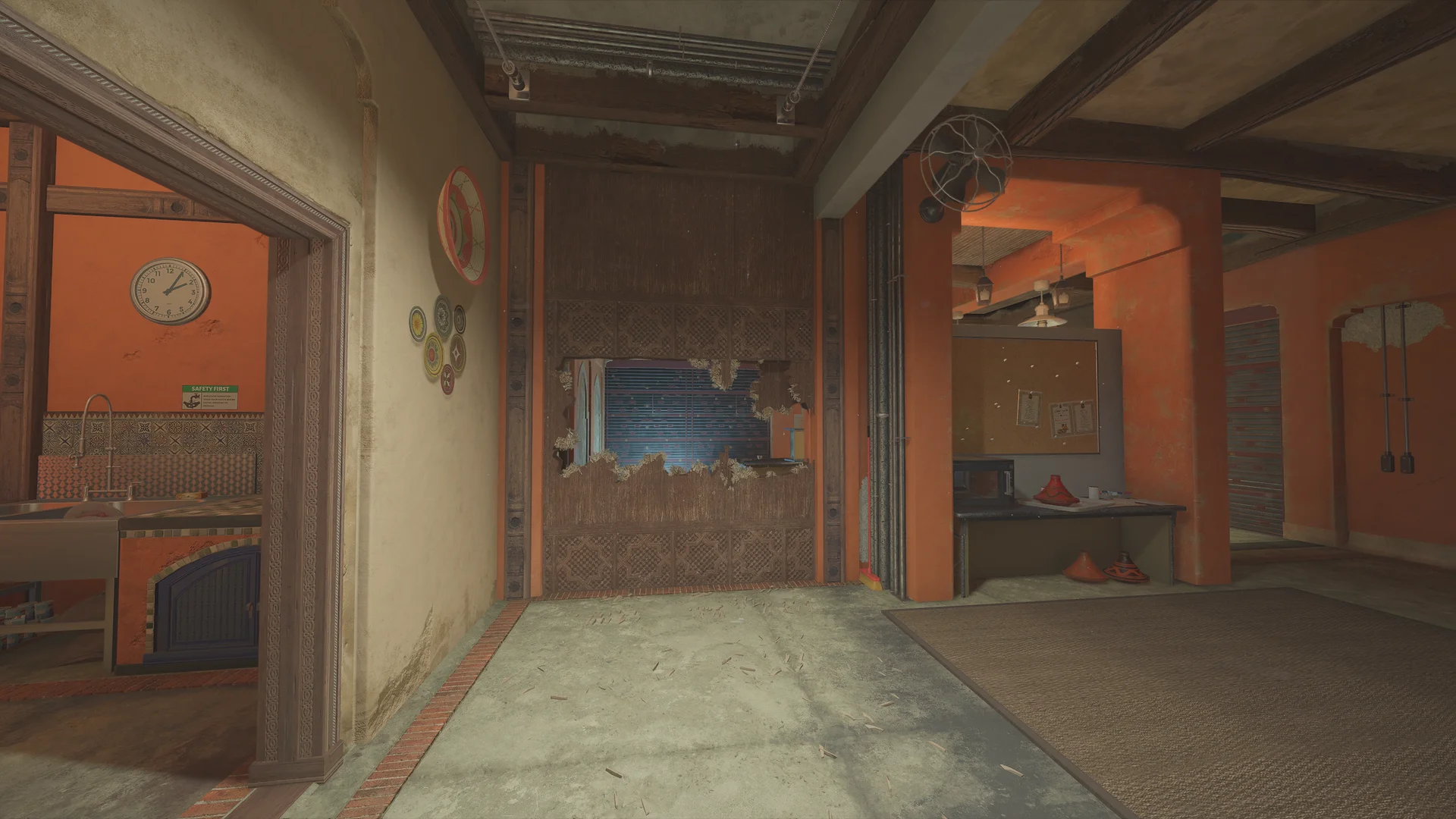 Hallway on Fortress 1F with an arched doorway to a kitchen, decorative wall plates, a breach hole through a wood-panel wall, and a wall fan