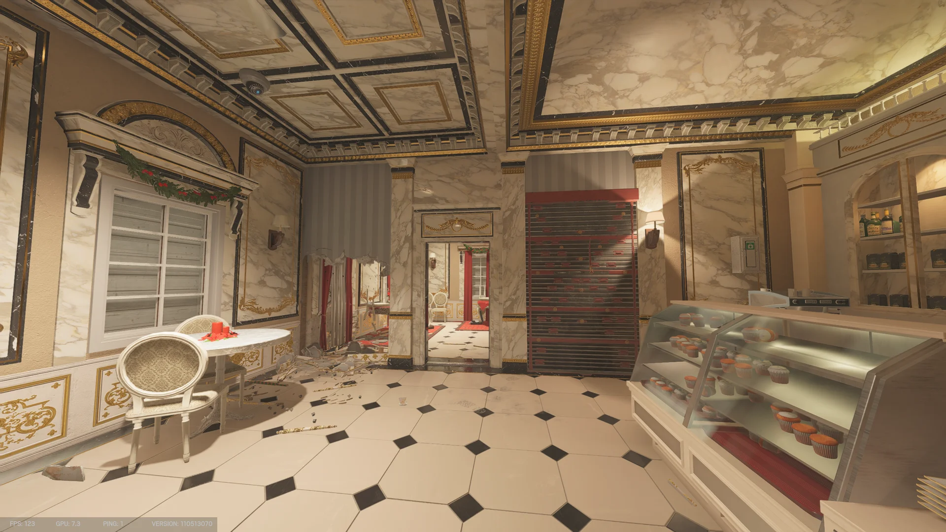 Patisserie on Kafe Dostoyevsky 1F with a glass pastry case of cupcakes, a table and chair, a reinforced shutter, and a checkered tile floor