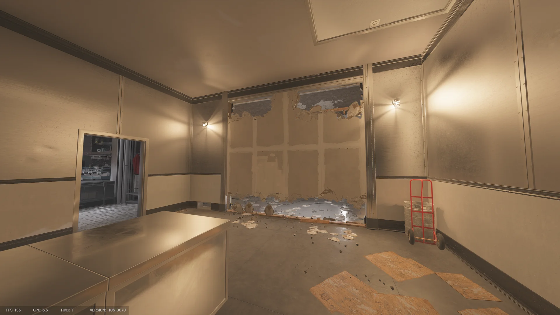 Storage room on Kafe Dostoyevsky 1F with a stainless counter, a stripped wall with a breach hole, a wall mirror, and a red hand truck