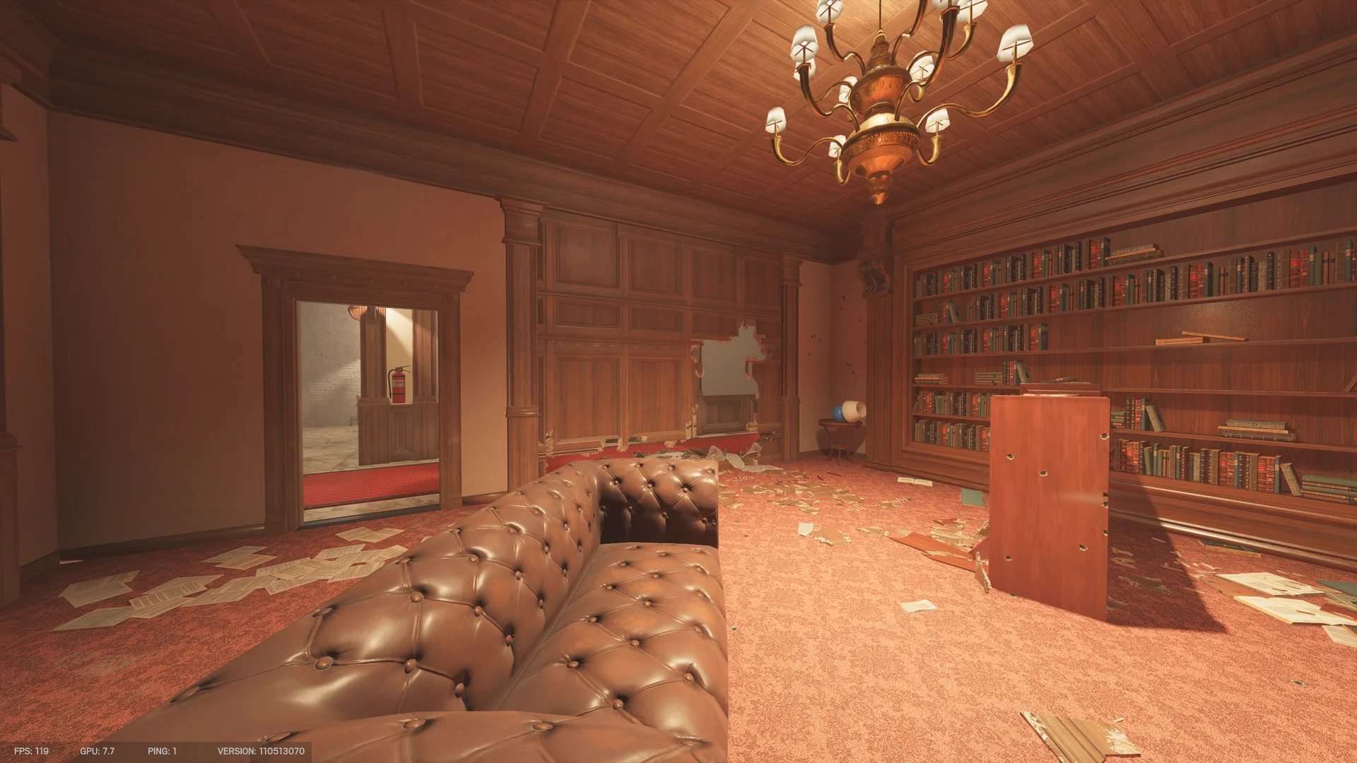 Library lounge on Kafe Dostoyevsky 2F with a tufted leather sofa, tall bookshelves, a chandelier, a mirrored doorway, and scattered papers
