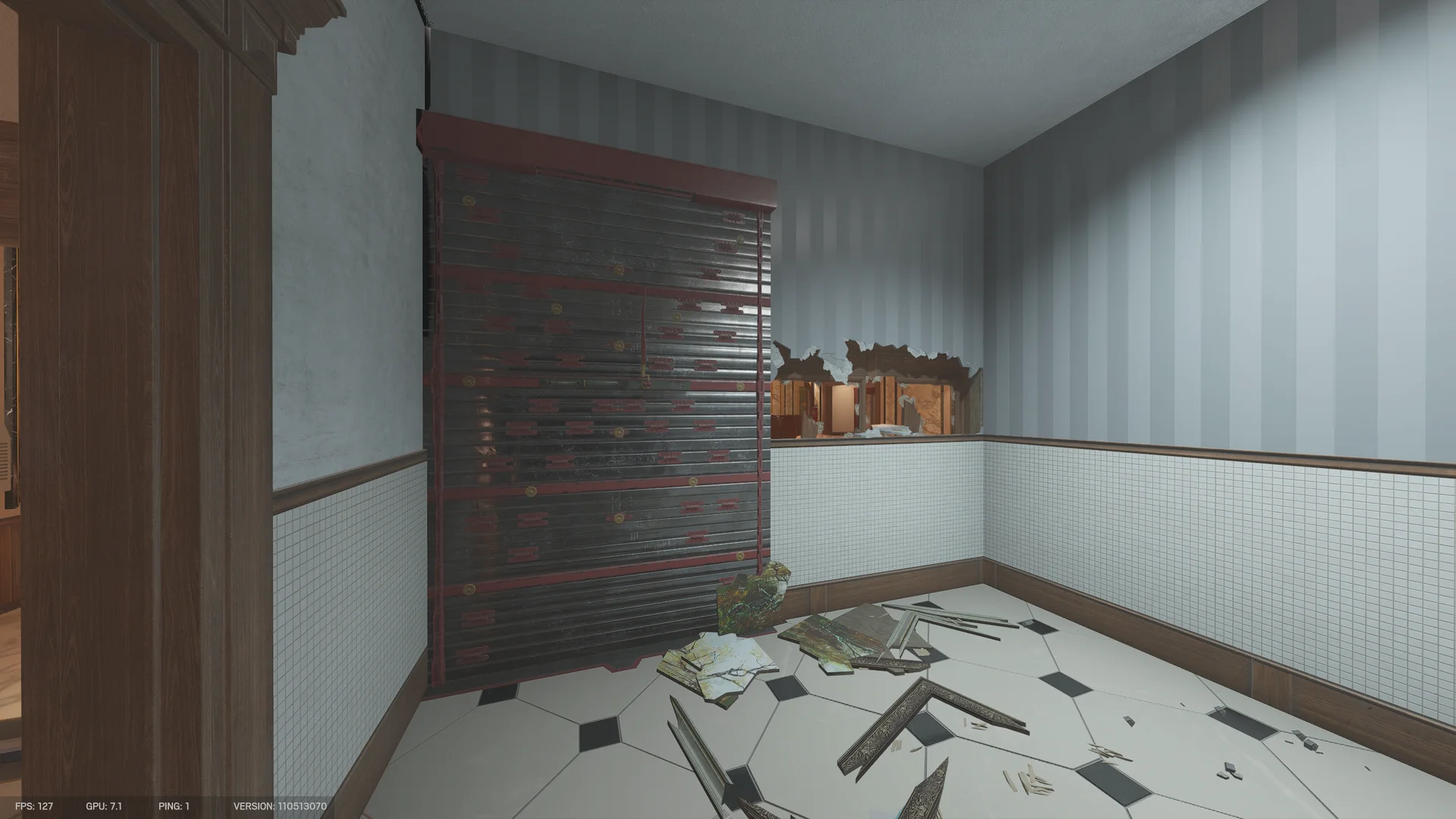 Restroom on Kafe Dostoyevsky 2F with a reinforced shutter, a breach hole through a wall, tiled walls, and fallen picture frames on the floor