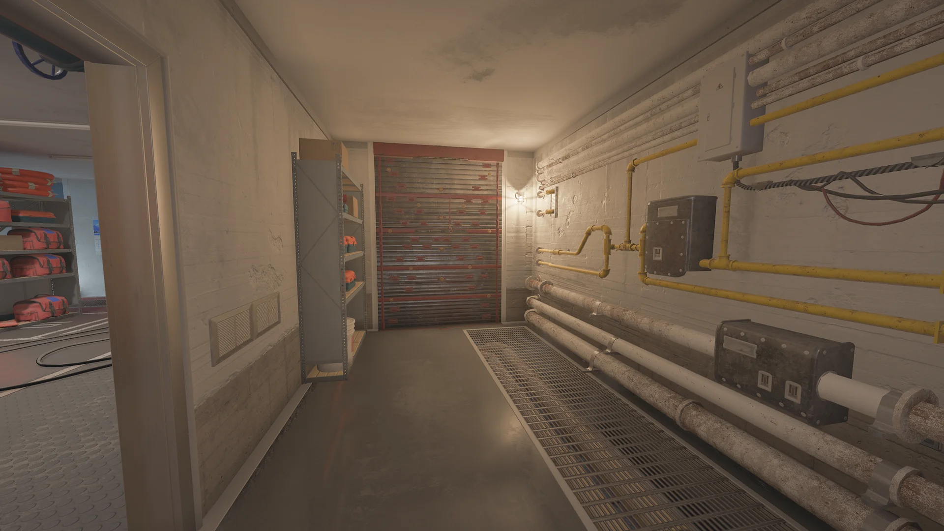 Utility corridor in the Kanal basement with wall-mounted pipes, a reinforced shutter, shelving of life vests, a wall lamp, and a floor grate