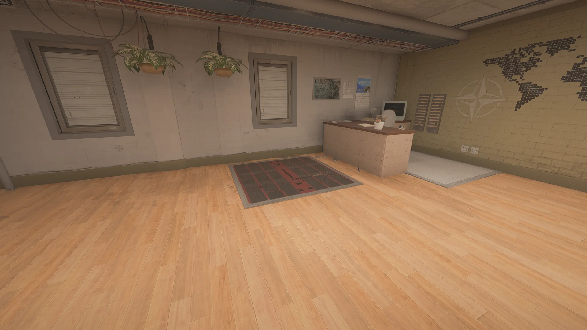Office in the Kanal basement with a reception desk, a vintage monitor, a reinforced floor hatch, hanging plants, and a wall map stencil
