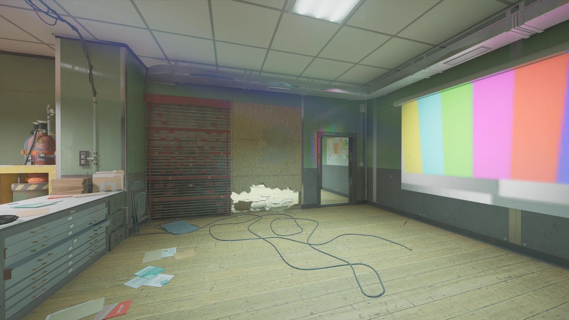 Room on Lair 1F with a reinforced shutter, an OSB-patched wall, a gas cylinder, a flat-file cabinet, and color bars projected on the wall