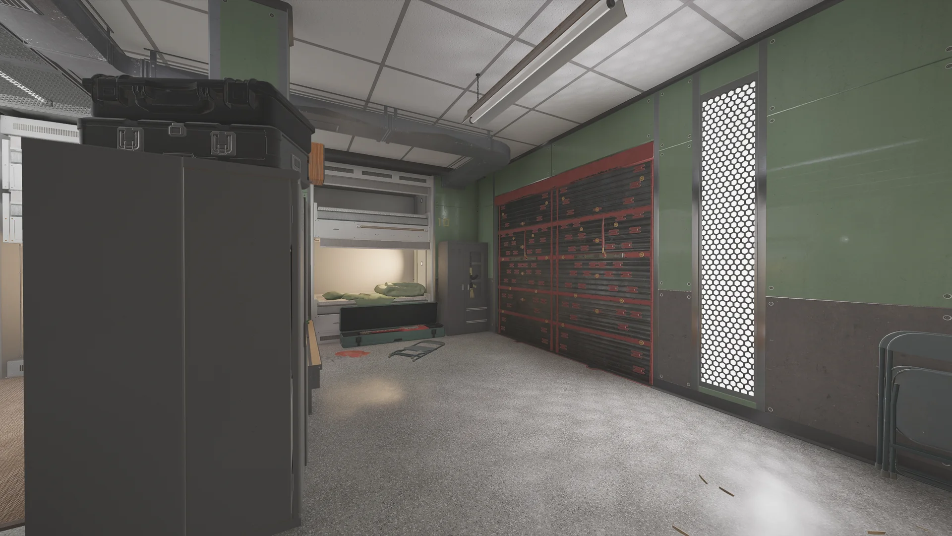 Dorm on Lair 1F with a metal bunk bed, an open footlocker, a road case on a cabinet, a reinforced shutter, and a perforated light panel