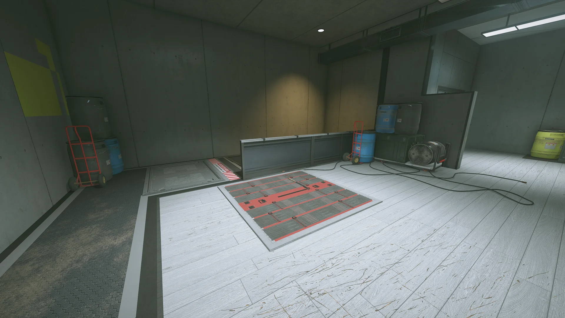 Utility room in the Nighthaven Labs basement with a reinforced floor hatch, hand trucks, blue barrels and a coiled hose