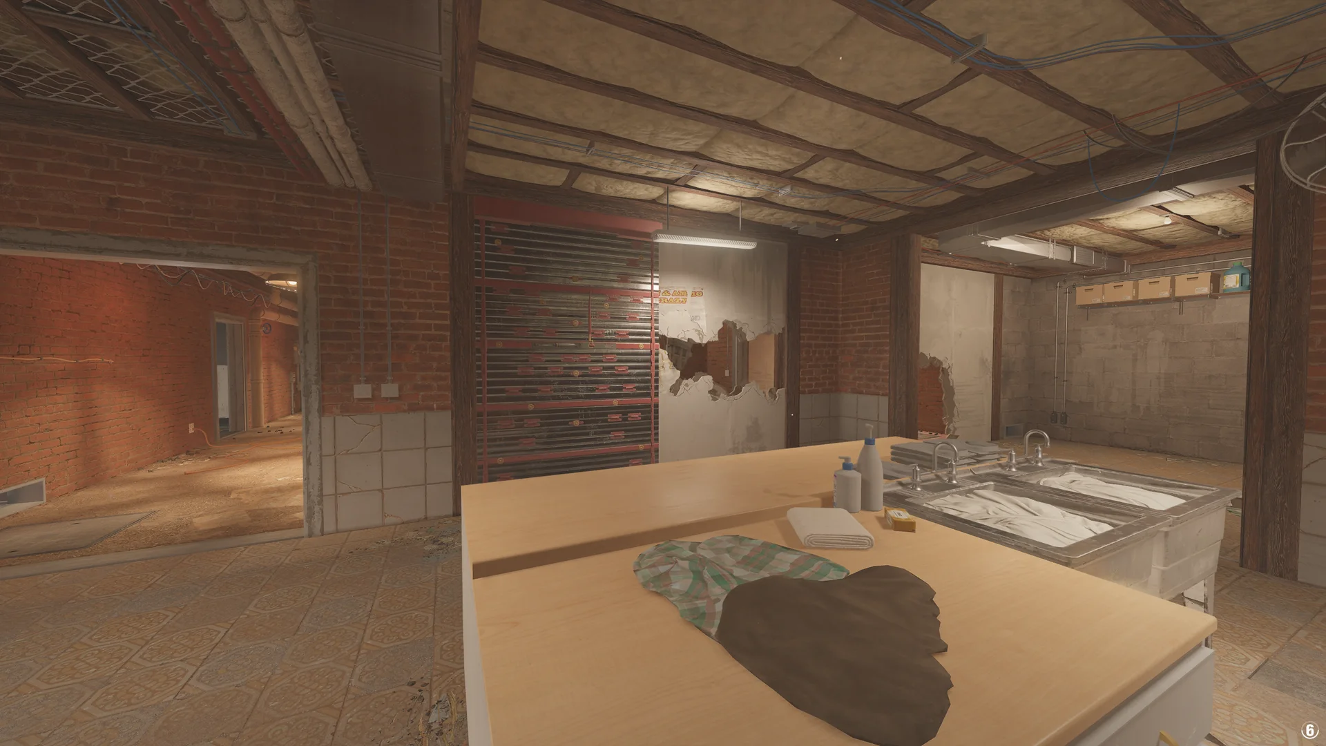 Laundry room in the Oregon basement with a folding table, twin sinks, a reinforced shutter and a breached poster wall