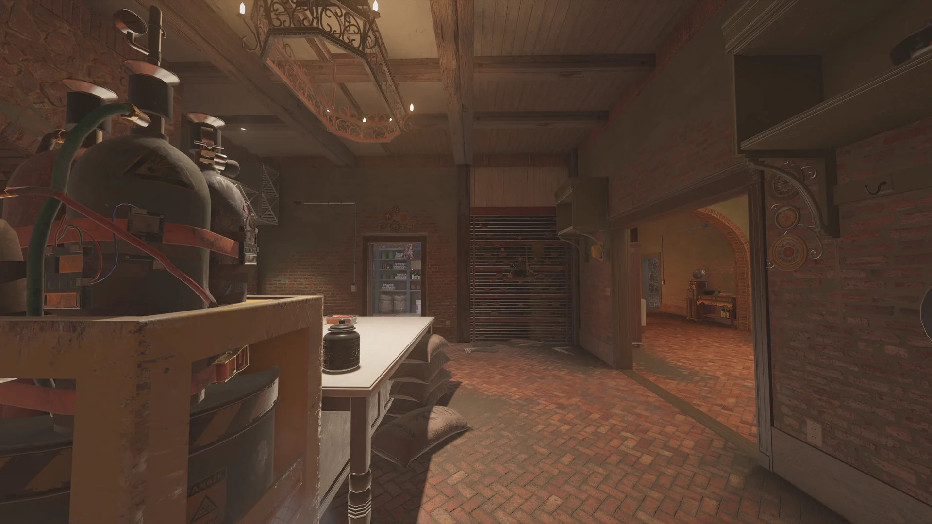 Brick kitchen on Villa 1F with gas cylinders on a counter, a white table, burlap sacks, and a wrought-iron chandelier