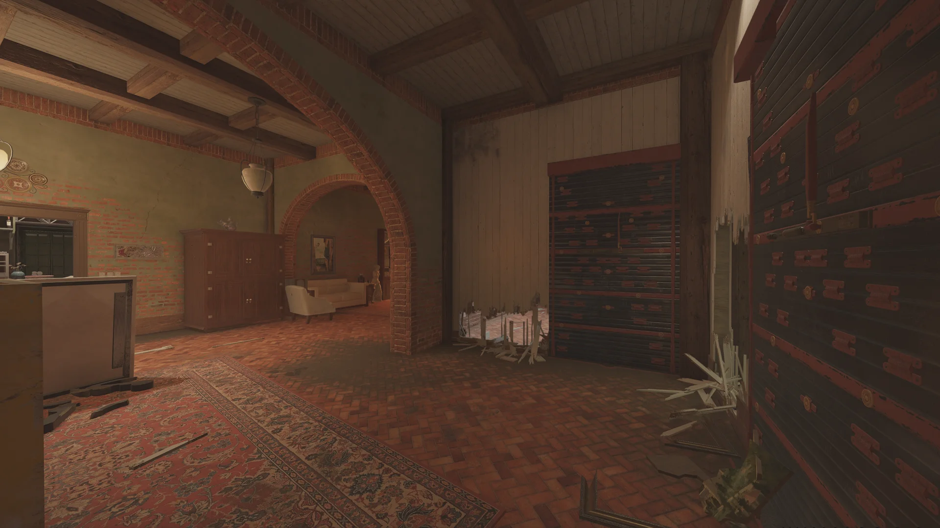 Living area on Villa 1F with brick arches, a red rug, a wooden armoire, a white sofa beyond, and a broken slatted panel
