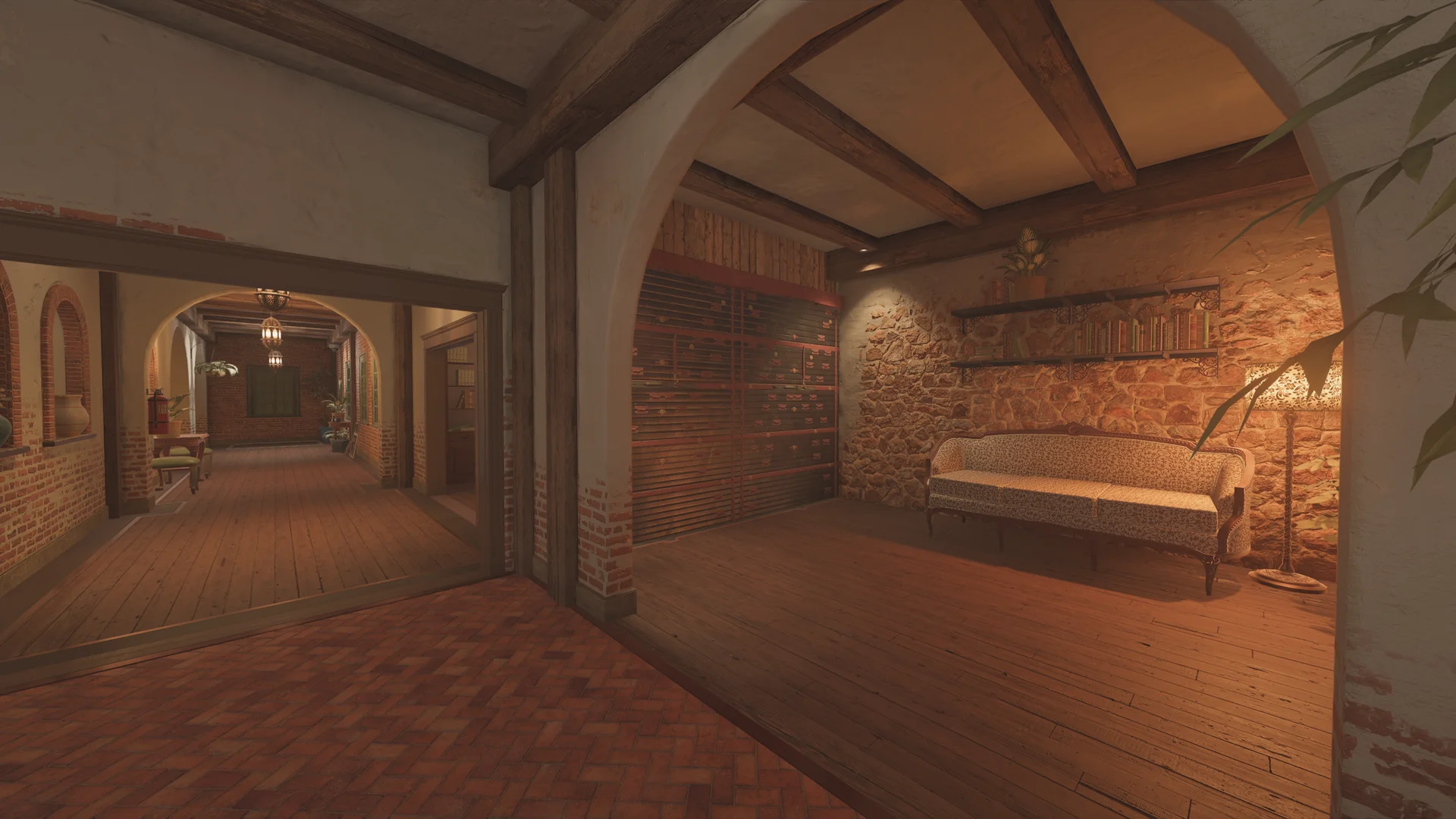 Sitting nook on Villa 2F with a patterned antique sofa on a stone wall, a floor lamp, book shelves, and a slatted panel