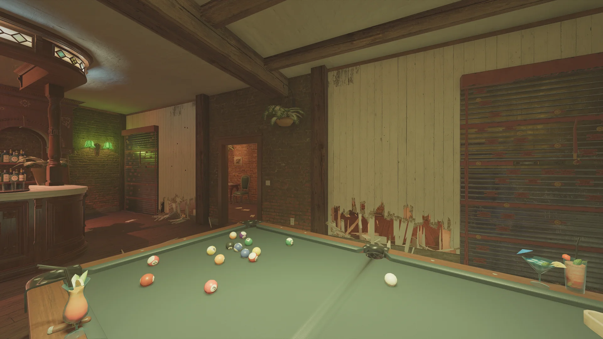 Billiards room on Villa 2F with a green pool table, a wooden bar, red-and-black slatted shutters, and a hanging plant